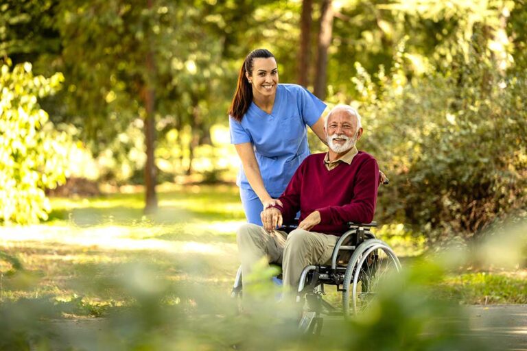 A senior adult reviewing paperwork at a table with a family member, both focused and discussing forms.